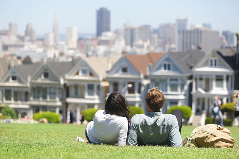 A man and a woman looking at the Painted Ladies in San Francisco, CA